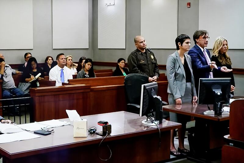 Lori Vallow, aka Lori Daybell, right, appears in court in Kauai, Hawaii on Friday, Feb. 21, 2020. Seated in the gallery is her husband, Chad Daybell, front row in a blue tie.