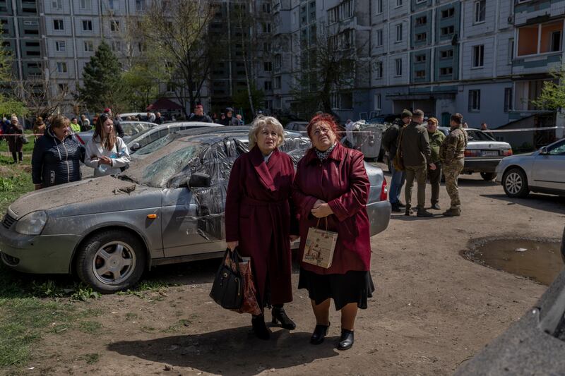 Residents watch the destruction of a residential building that was hit during a Russian attack in Uman, central Ukraine.