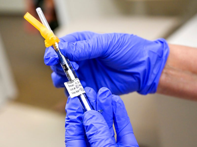 Nurse Mary Ezzat prepares to administers a Pfizer COVID-19 booster shot.