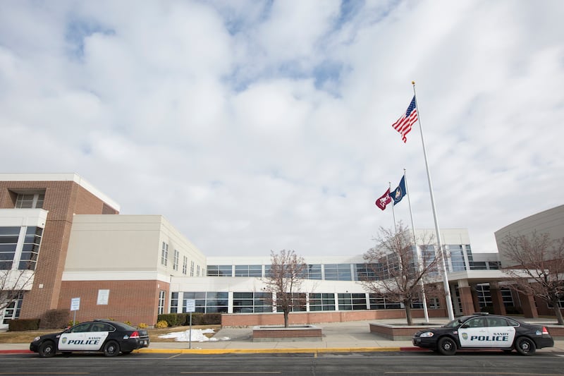 Sandy police vehicles sit outside Jordan High School on Friday, Jan. 26, 2018, after an overnight threat of violence. Law enforcement and district officials, who searched the school and investigated the threat, believe that it is unfounded, but parents we