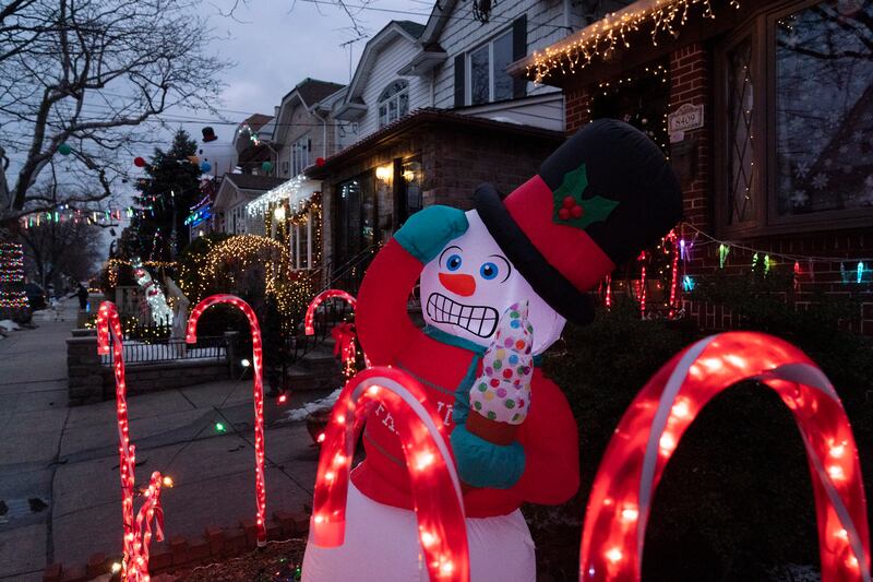 An inflatable snowman and candy canes are part of the decorations that adorn houses in Brooklyn’s Dyker Heights neighborhood.