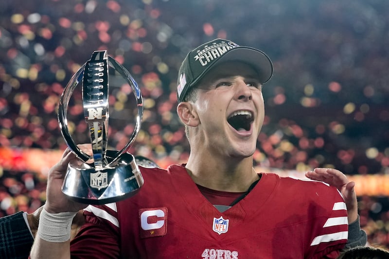 San Francisco 49ers quarterback Brock Purdy celebrates with the trophy after defeating the Detroit Lions in the NFC Championship game in Santa Clara, Calif., on Jan. 28, 2024.