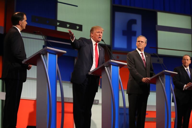 Scott Walker, Donald Trump, Jeb Bush and Mike Huckabee take the stage for the Republican presidential debate at the Quicken Loans Arena Aug. 6, 2015, in Cleveland.