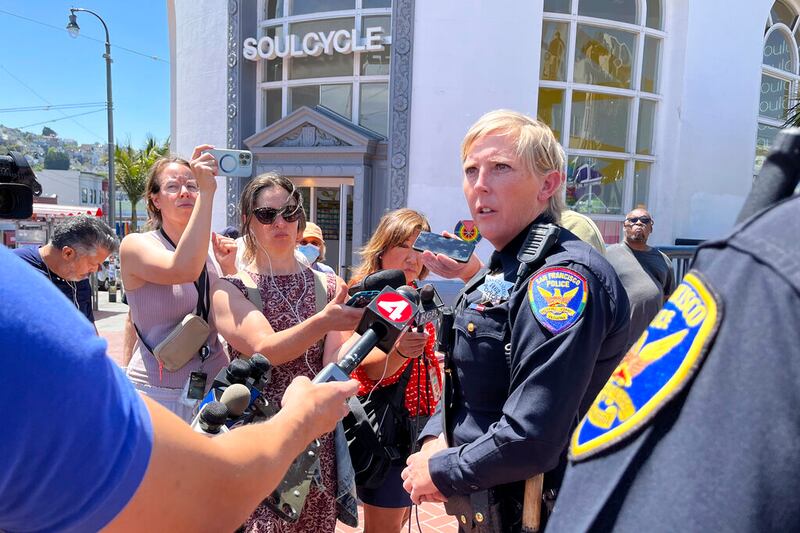 San Francisco Police Officer spokesperson Kathryn Winters speaks with reporters outside the entrance to the Castro Muni station.