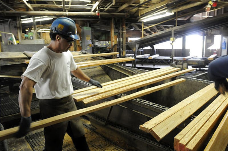 A worker sorts lumber recently in the DeArmond Mill in Coeur d'Alene, Idaho. The soon-to-close mill, owned by Stimson Lumber, is the last one operating along the Spokane River.