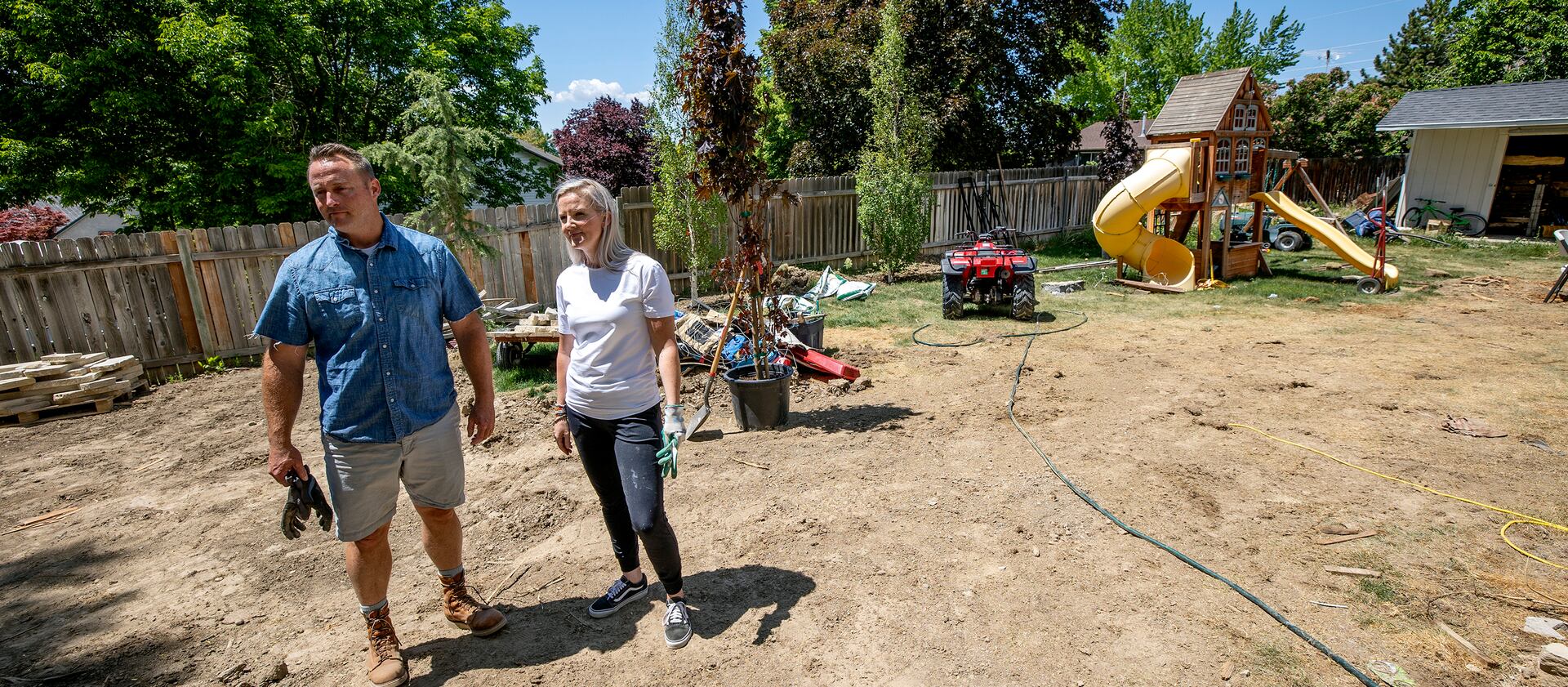 Cody Jolley, left, and his wife, Julia, stand in the backyard of their home in Pleasant Grove.
