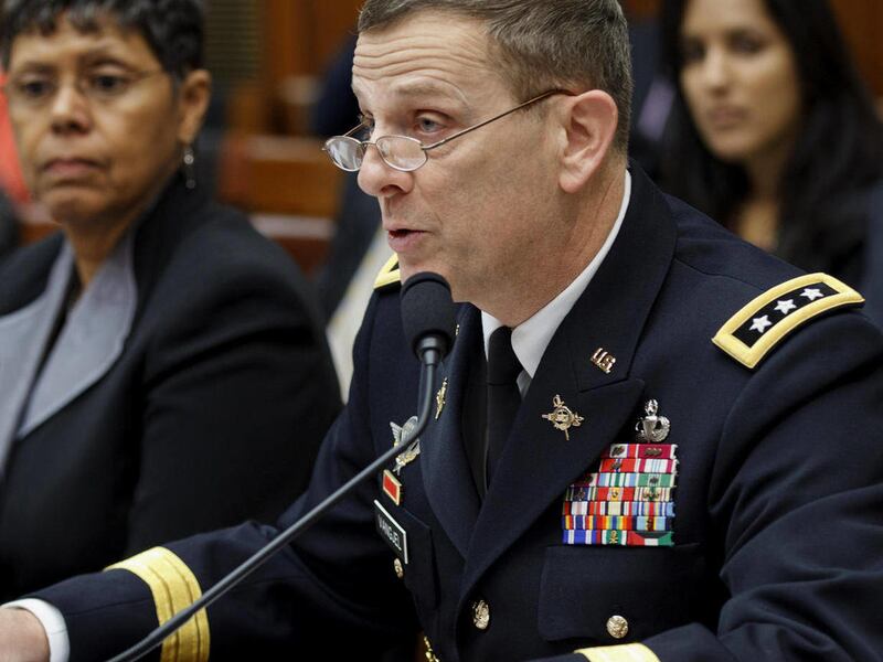 Army Inspector General Lt. Gen. Peter Vangjel testifies on Capitol Hill in Washington, Friday, Feb. 3, 2012, before a House Armed Services subcommittee hearing on Arlington National Cemetery. At left is Belva Martin, a Government Accountability Office off