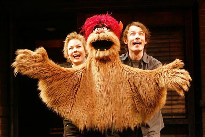 In this theater publicity image released by Sam Rudy Media Relations, Jennifer Barnhart, left, Trekkie Monster and Christian Anderson, right, are featured in "Avenue Q," playing in New York.