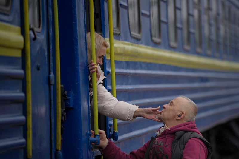 A woman bids a man goodbye after boarding a train bound for Lviv, in Kyiv, Ukraine, on Thursday, March 3, 2022.