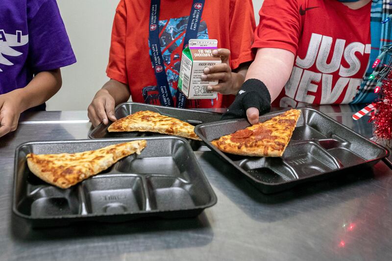 Second-grade students select their meals during lunch break in the cafeteria at an elementary school in Scottsdale, Ariz.