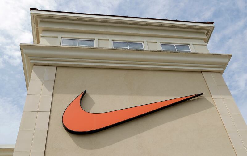 In this file photo dated Tuesday, Sept. 4, 2018, a Nike company logo is displayed outside a Nike store in Charlotte, N.C. The company is under fire from some who think one of its shoe logos is offensive to Muslims.