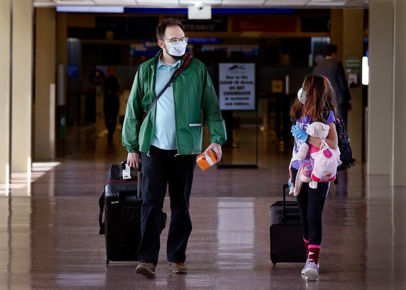Matt Lemmon and his daughter Celeste walk through the Salt Lake City International Airport on April 8, 2020.