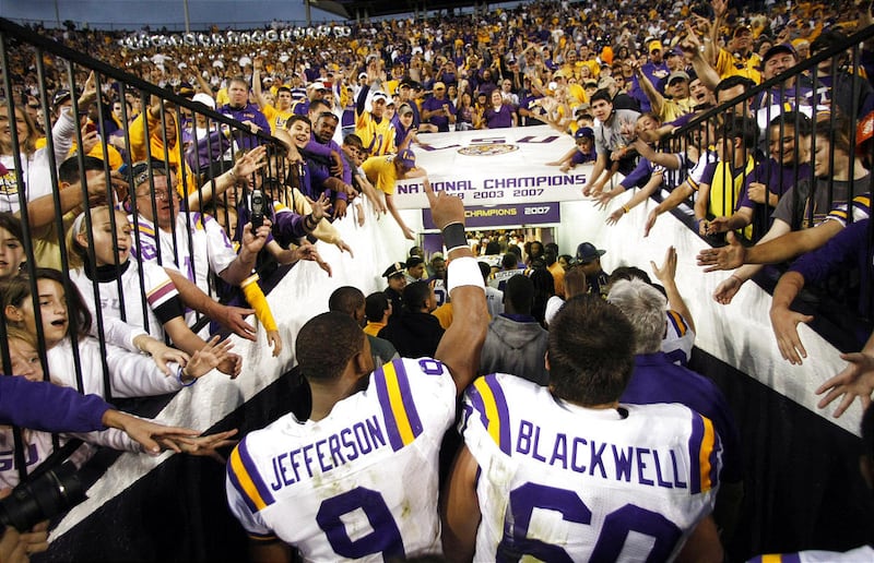 Fans cheer as LSU quarterback Jordan Jefferson and guard Will Blackwell head into the tunnel after their 41-17 victory Friday over No. 3 Arkansas. in an NCAA college football game in Baton Rouge, La., Friday, Nov. 25, 2011.