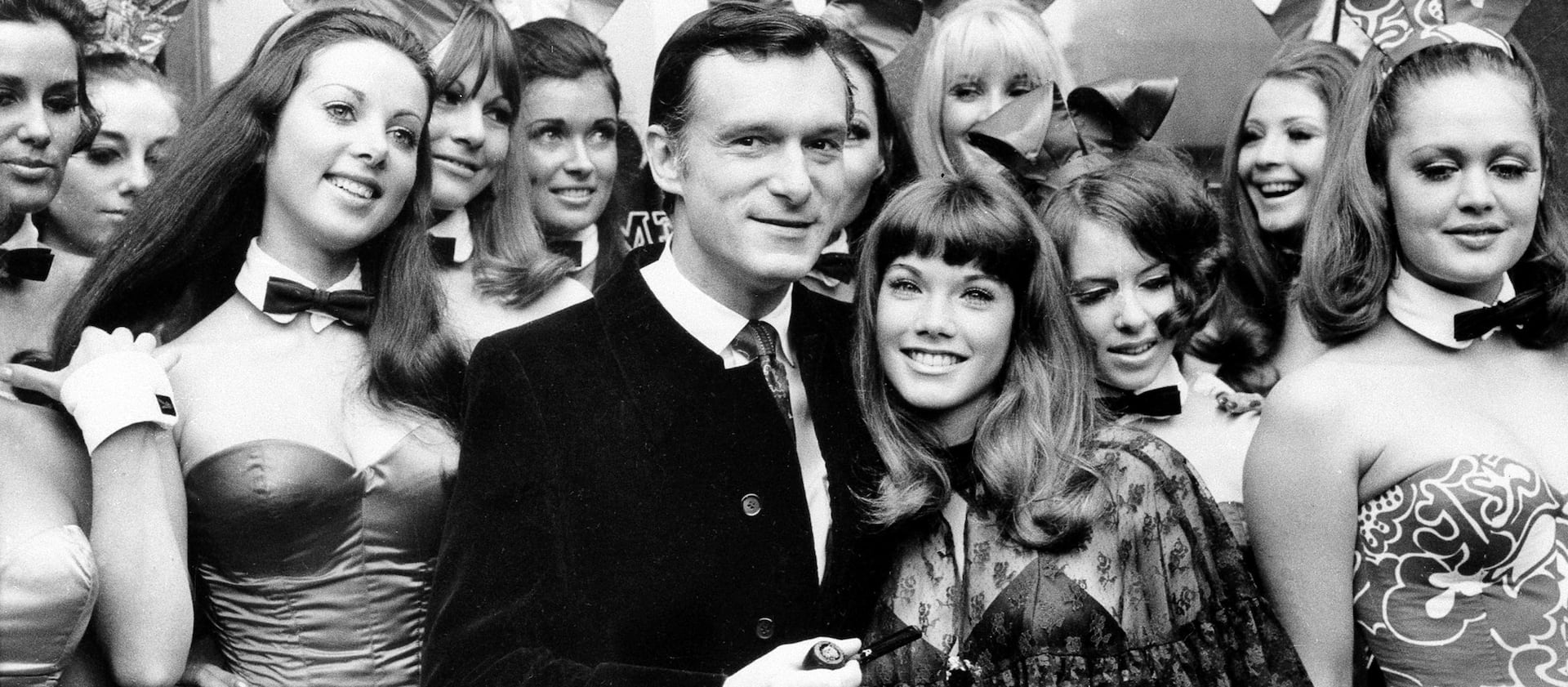 In this Sept. 5, 1969, file photo, Hugh Hefner, publisher and owner of Playboy Magazine, and his 19-year-old girlfriend, Barbara Benton, are surrounded by “Bunny Girls” at the Playboy Club in London.