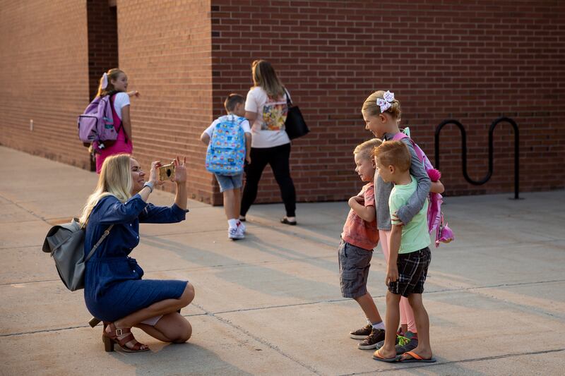 Kristen Romero takes a photo of her children at Altara Elementary in Sandy.