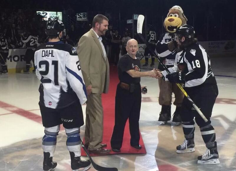Johnny Burt gets ready to drop the puck at a Utah Grizzlies game.