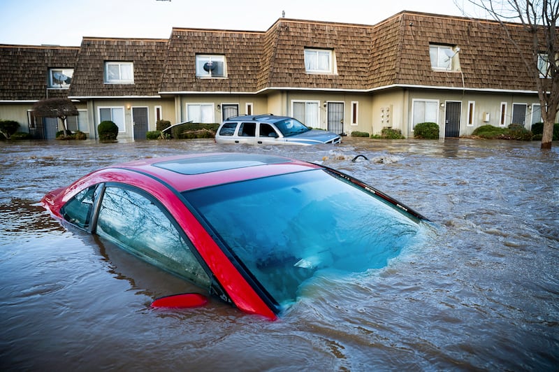A car is nearly submerged under water in Merced, Calif., on Tuesday, Jan. 10, 2023.