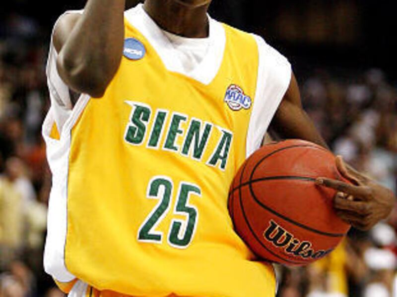 Siena's Ronald Moore gets pumped up as the Saints romp over the Vanderbilt Commodores in Friday NCAA action.