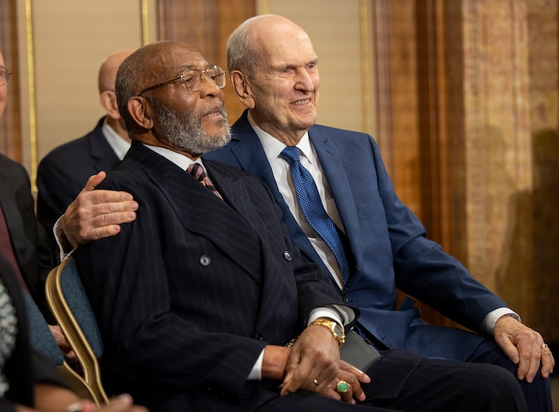 President Russell M. Nelson, a Latter-day Saint leader, sits with his arm around the Rev. Amos C. Brown of the NAACP.