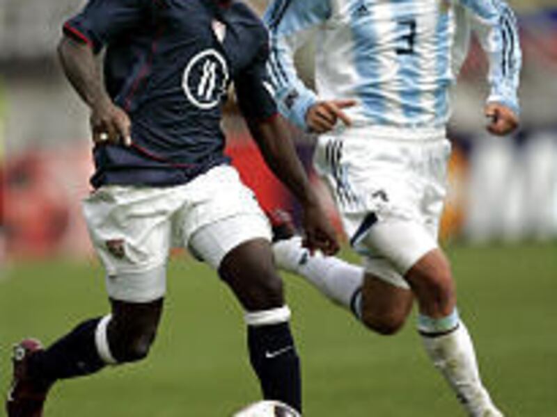 U.S. player Freddy Adu, left, is defended by Argentina's Lautaro Formica during Saturday's U20 match.