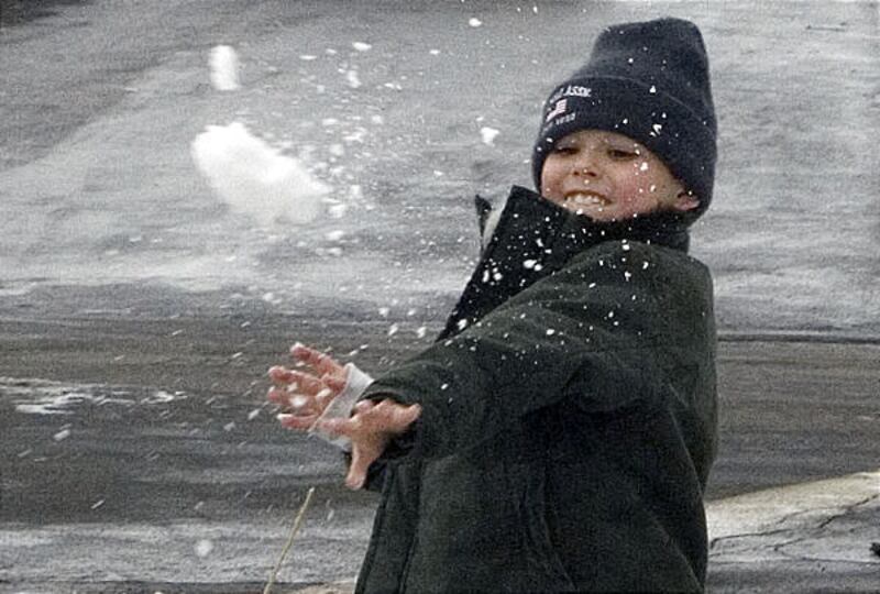 Colby Hodgson tosses a snowball at his brother Ethan as they engage in an impromptu snowball fight in Salt Lake City Monday. The brothers were on their way to Starbucks to exchange a toy for a cup of hot chocolate.