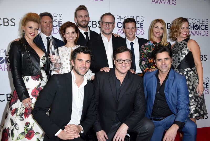 Jodie Sweetin, back row from left, Jeff Franklin, Candace Cameron Bure, John Brotherton, Dave Coulier, Scott Weinger, Lori Loughlin, Andrea Barber, and front row from left, Juan Pablo Di Pace, Bob Saget and John Stamos pose in the press room with the award for favorite premium comedy series for “Fuller House” at the People’s Choice Awards at the Microsoft Theater on Wednesday, Jan. 18, 2017, in Los Angeles.