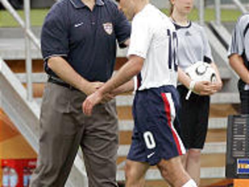 USA's Claudio Reyna, right, leaves the pitch after he was substituted by coach Bruce Arena during World Cup.
