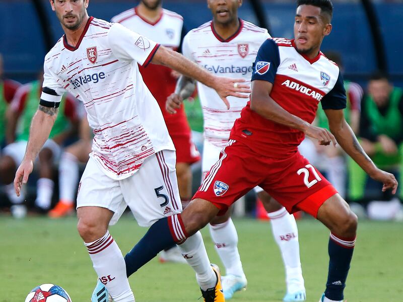 FC Dallas forward Jesus Ferreira (27) and Real Salt Lake midfielder Kyle Beckerman (5) become entangled during the first half of an MLS soccer match in Frisco, Texas, Saturday, July 27, 2019. (Stewart F. House/The Dallas Morning News via AP)