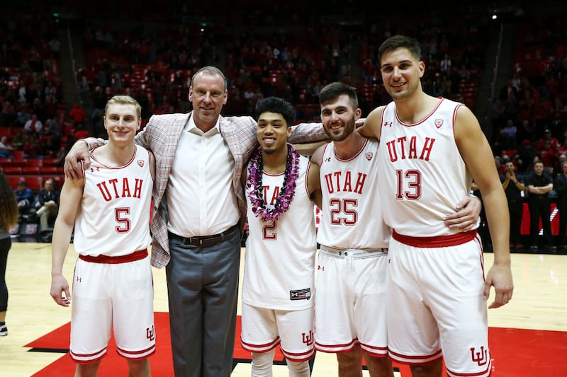 Utah Utes head coach Larry Krystkowiak stands with Utah Utes guard Parker Van Dyke (5), Utah Utes guard Sedrick Barefield (2), Utah Utes guard Beau Rydalch (25) and Utah Utes forward Novak Topalovic (13) during the senior night presentations after the Uta