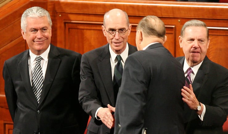 Elder Dieter F. Uchtdorf, Elder Henry B. Eyring and Elder Jeffrey R. Holland (right) greet President Thomas S. Monson before the beginning of the Saturday morning session of the 177th semi annual conference of the Church of Jesus Christ of Latter-day Saints October 6, 2007. Elder Eyring was named second counselor in the First Presidency during the session.