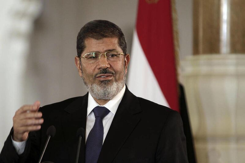 FILE - In this Friday, July 13, 2012 file photo, Egyptian President Mohammed Morsi speaks to reporters during a joint news conference with Tunisian President Moncef Marzouki, unseen, at the Presidential palace in Cairo, Egypt. Egypt's Islamist president