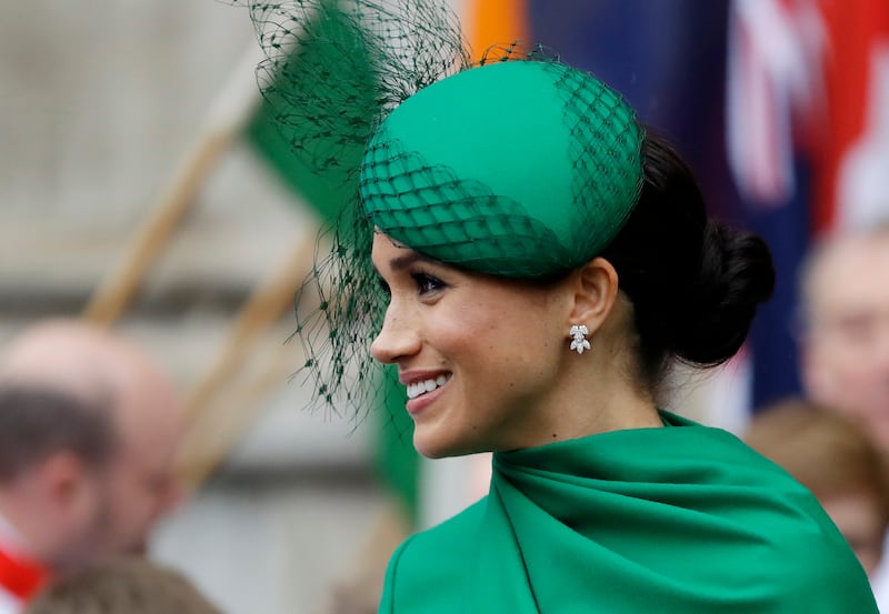 In this Monday, March 9, 2020 file photo, Britain’s Meghan, the Duchess of Sussex receives flowers as she leaves after attending the annual Commonwealth Day service at Westminster Abbey in London.