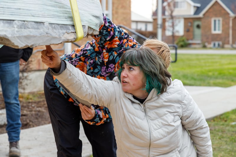 Objects conservators inspect the bottom of a petroglyph rock on Monday, December 8, 2025, in Tremonton, Utah, before transporting it to Provo, Utah, for cleaning and preservation.