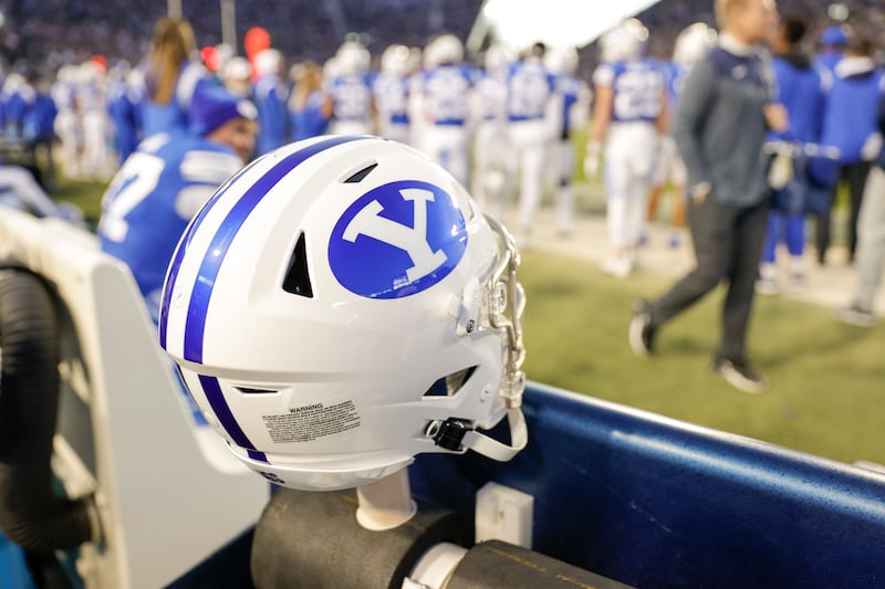 A BYU helmet sits of the sidelines during a game at the LaVell Edwards Stadium field in Provo on Friday, Oct. 28, 2022.