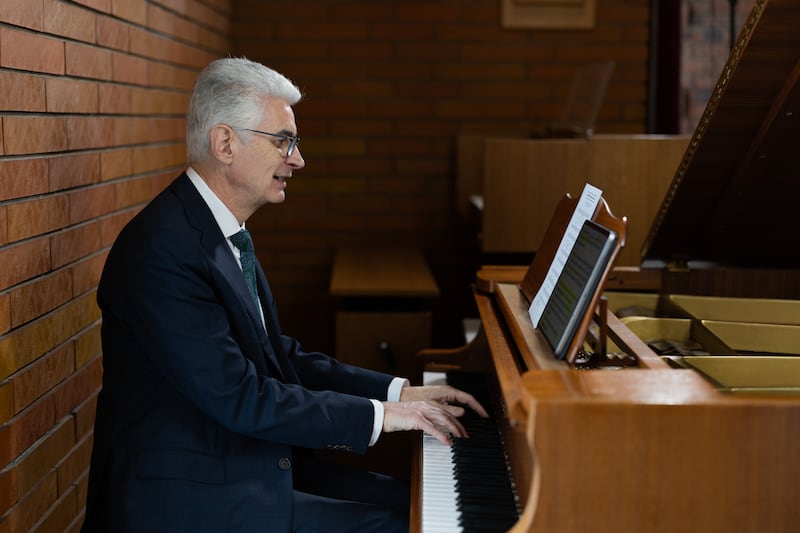 Elder Gérald Caussé of the Quorum of the Twelve Apostles plays the piano on Feb. 23, 2026, at the Paris France Stake Center in Versailles, France, where he served as stake president more than 20 years ago.