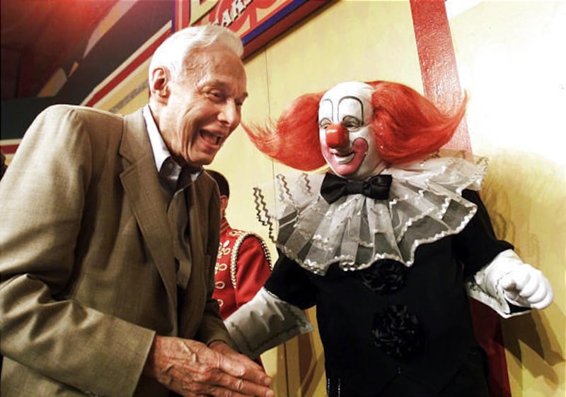 Bozo the Clown, played by Joey D'Auria, laughs in July 2001 with Alan Livingston, who created Bozo in 1946.