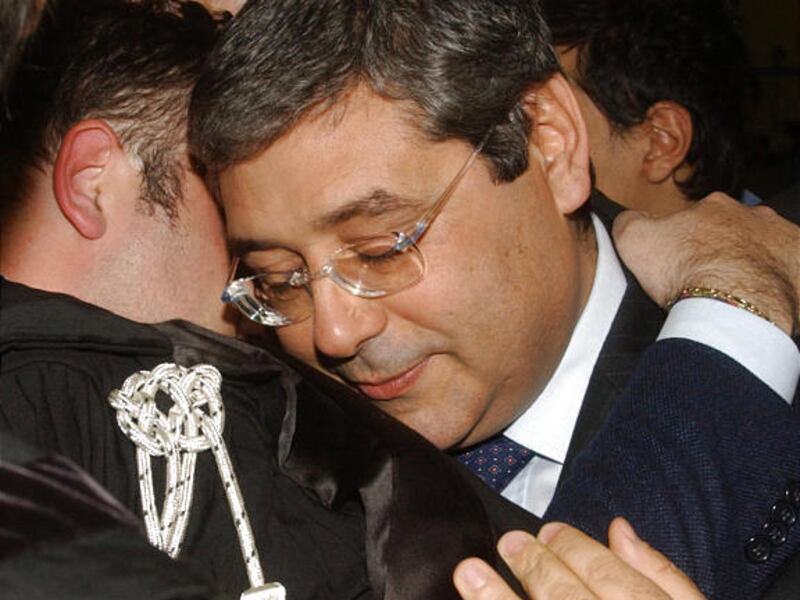 Sicily's governor Salvatore Cuffaro, right, is hugged by his lawyer Marcello Montalbano in a Palermo's court, after the reading of the sentence that convicted him to 5 years in prison and banned him from holding public office.