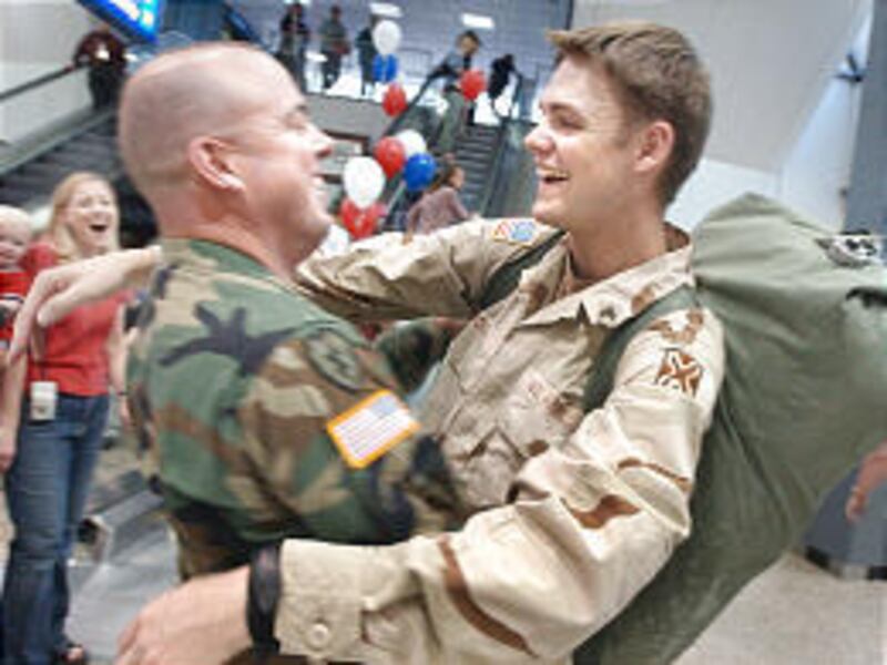 Sgt. 1st Class Daryl Hall, left, greets Sgt. Keith Moon at the Salt Lake City International Airport at the brigade's homecoming on Wednesday.