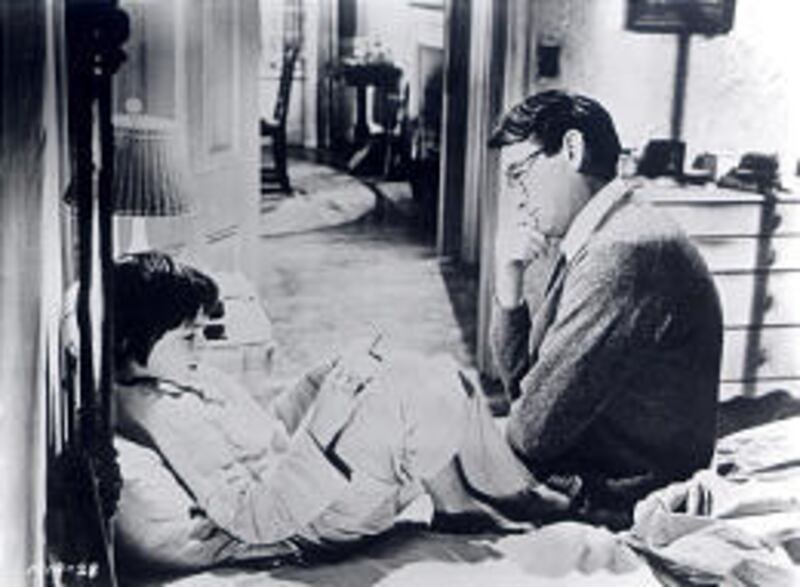 Scout (Mary Badham) and Atticus Finch (Gregory Peck) share a moment in “To Kill a Mockingbird.”