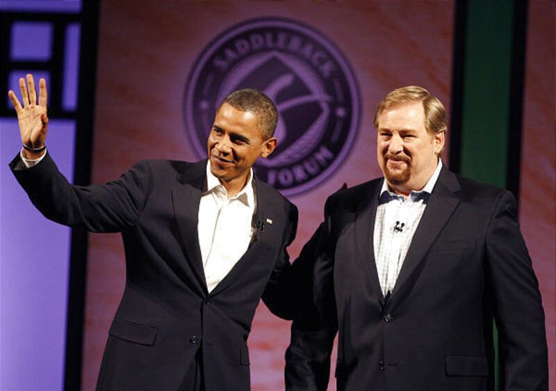 Then-presidential candidate Barack Obama joins pastor Rick Warren of Saddleback Church on Aug. 16. Warren will offer the invocation at Obama's inauguration.