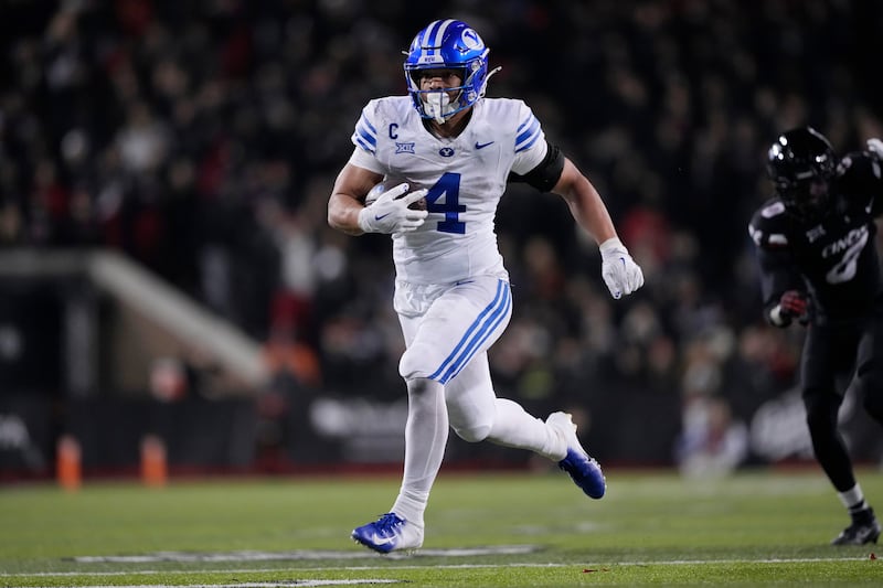 BYU running back LJ Martin (4) runs for a touchdown during game against Cincinnati, Saturday, Nov. 22, 2025, in Cincinnati.