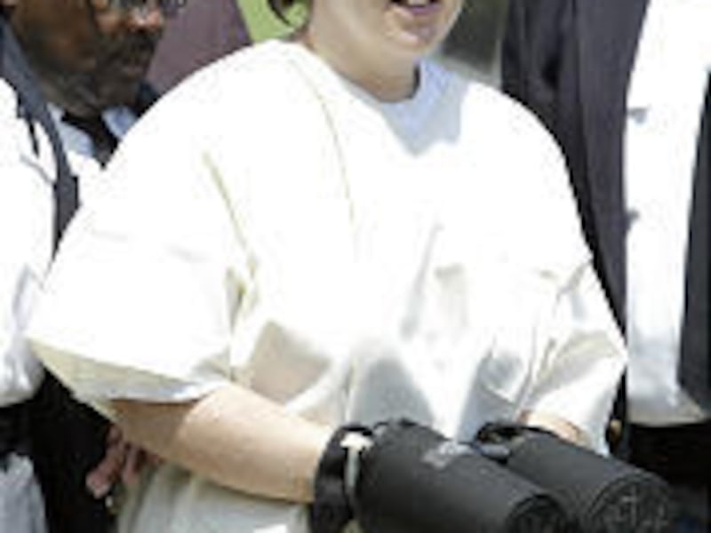 Jennifer Hyatte is led to court in Kingston, Tenn., Monday. Hyatte and her husband, George, were charged in the killing of a corrections officer.