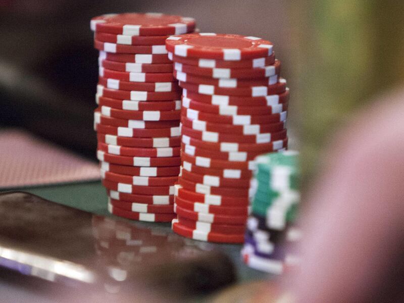 Poker chips are stacked in front of the players around the table as players take part in a game Wednesday, April 24, 2013 at Bout Time Pub and Grub in West Valley.