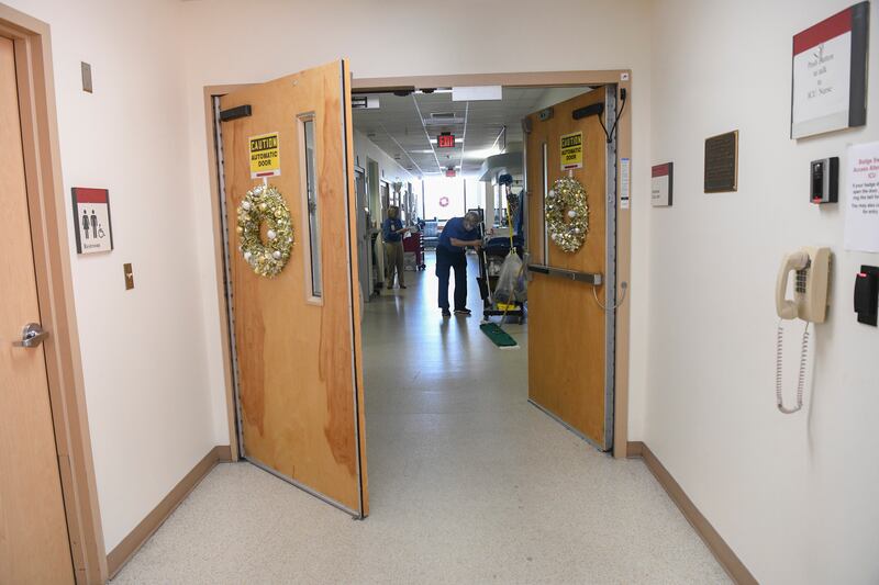 A custodian mops the floor in East Alabama Medical Center.