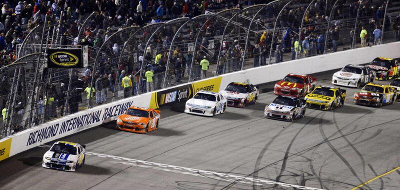 Carl Edwards (99) leads the pack after he jumped the restart during the NASCAR Sprint Cup Series auto race at Richmond International Raceway in Richmond, Va., Saturday, April 28, 2012.