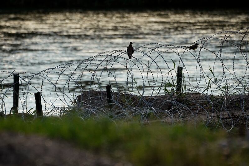Birds rest on razor wire, along the Rio Grande in Eagle Pass, Texas, July 6, 2023.