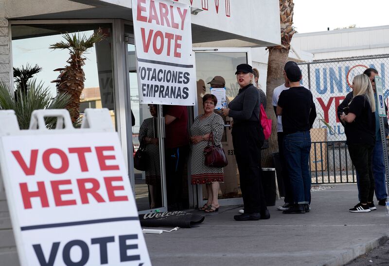 People wait in line at an early voting location at the culinary workers union hall in Las Vegas on Feb. 15, 2020.
