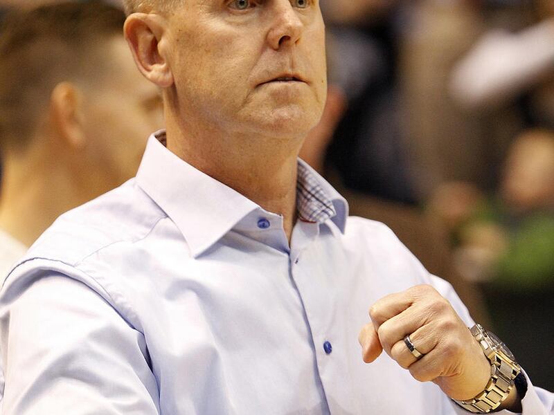 BYU Cougars athletic director Tom Holmoe participates in the BYU fight song in an NCAA women's basketball game against the Utah Utes at the Marriott Center in Provo, Saturday, Dec. 12, 2015.