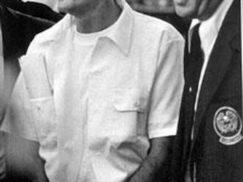 Condemned killer Gary Gilmore is led into a Utah County courtroom.