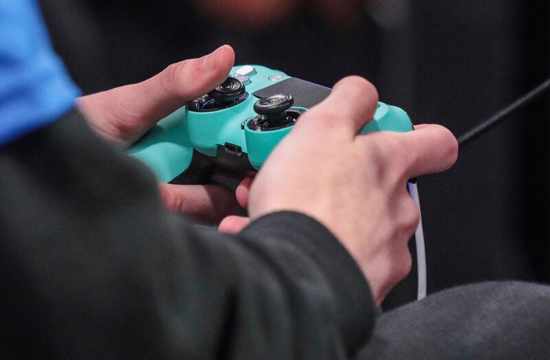 A contestant toggles a game controller during day one of the NBA 2k League (NBA2KL) professional esports playoffs, Wednesday, July 24, 2019, in Queens borough of New York.